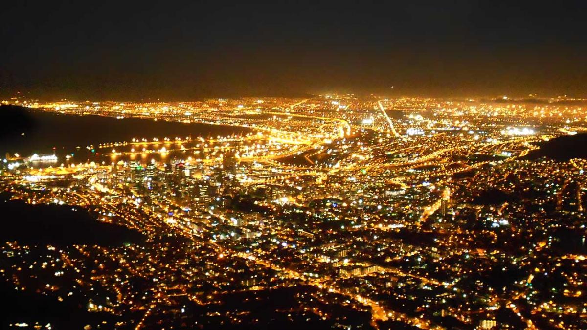 Aerial view of a city at night, creating a valley of light