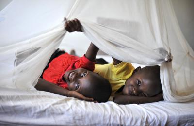 Twins Dorcas and Deborah Bendak, 7, under their old mosquito net at their home in Musoma. They both received a new mosquito net at Iringo B primary school.