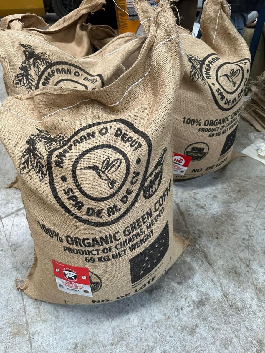 Large bags of coffee beans from Anepaan O' Deput coffee cooperative