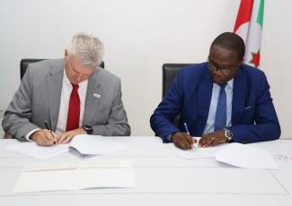 Paul Richardson, USAID Country Representative for Burundi signing the transfer or ownership documents with Ferdinand Bashikako, Permanent Secretary of the Ministry of Foreign Affairs and Development Cooperation 