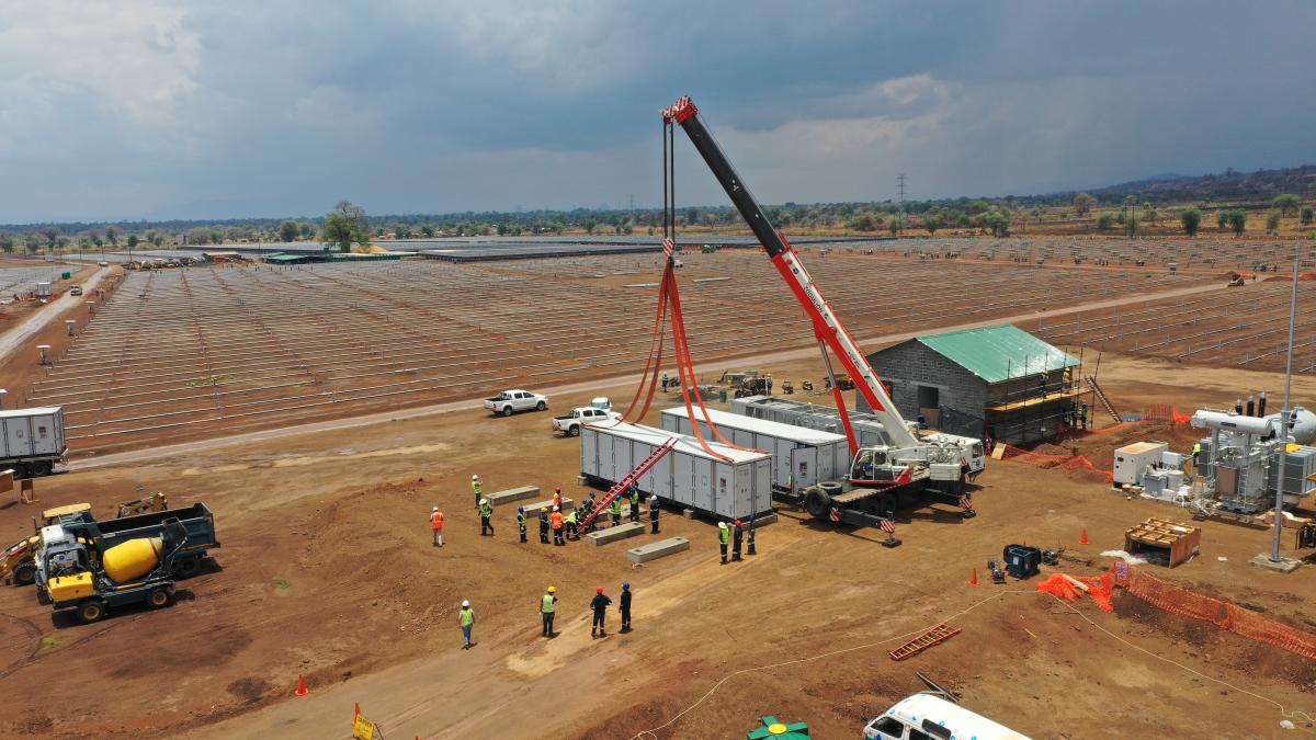 A crane lifting a container at the construction site of the Golomoti Solar Plant