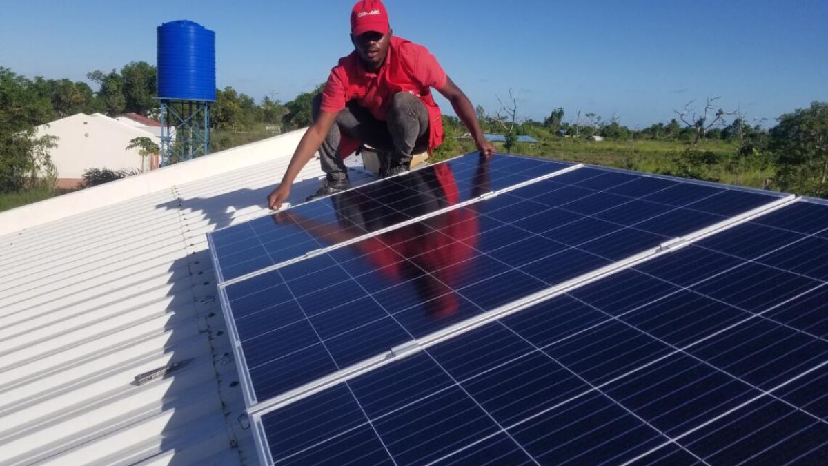 A SolarWorks! employee installing a PV panel in Sofala, Mozambique
