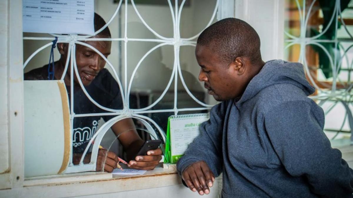 A client uses Jamii, a mobile-enabled private health insurance product that provides him and his family a low-cost insurance option that covers the care they prefer at private hospitals.