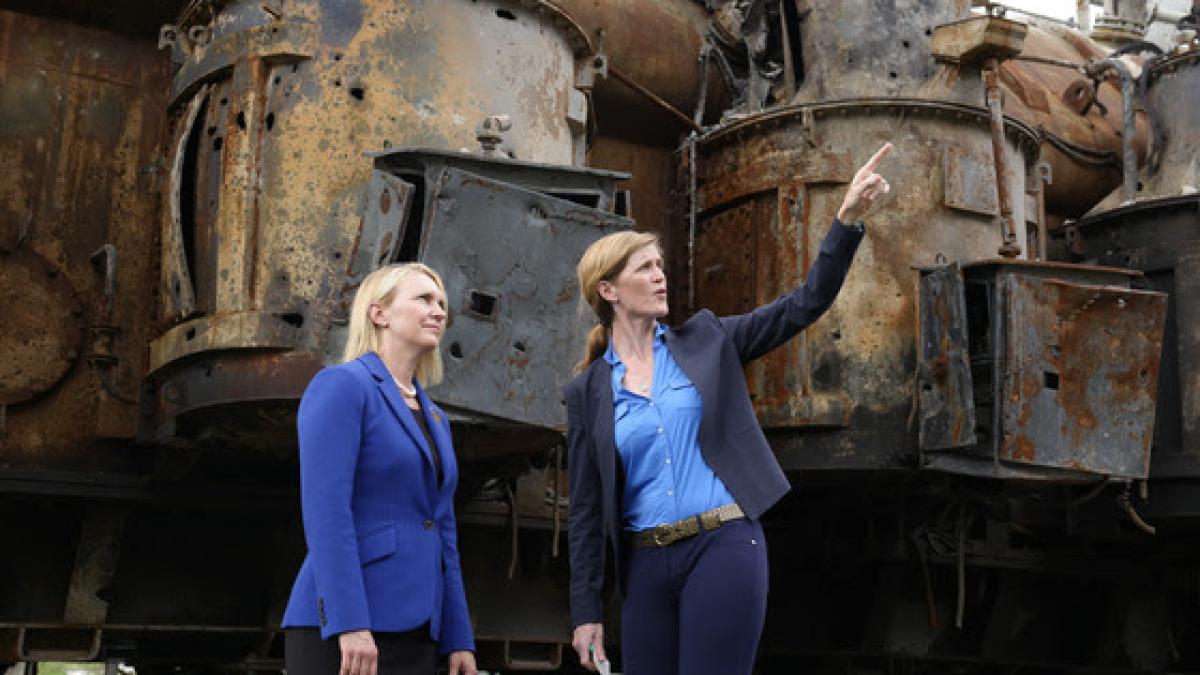 Administrator Power and Ambassador Brink stand in front of a damaged power transformer in Ukraine.