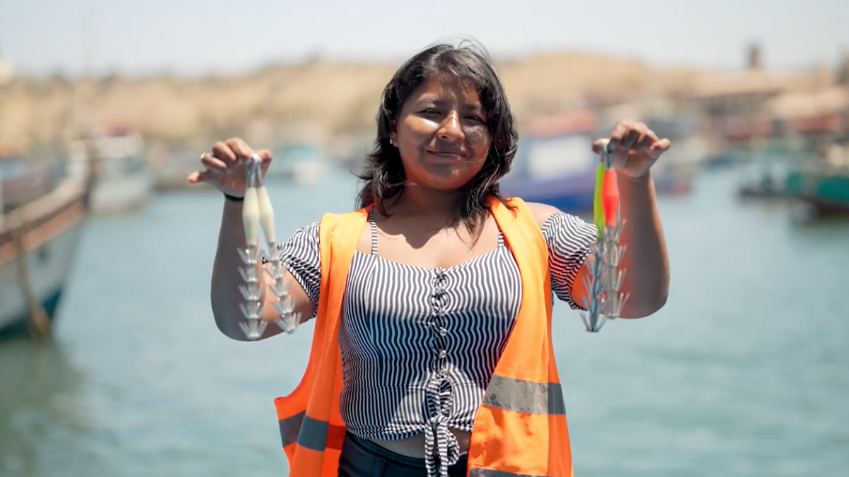 A woman holding two fishing hooks