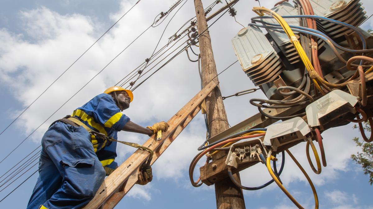 A Kenya Power employee working on a grid connection at Kasarani area, Kenya