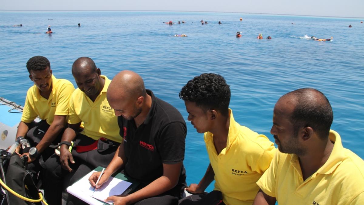 A team of HEPCA members discussing plans to reduce coral damage in the Red Sea.