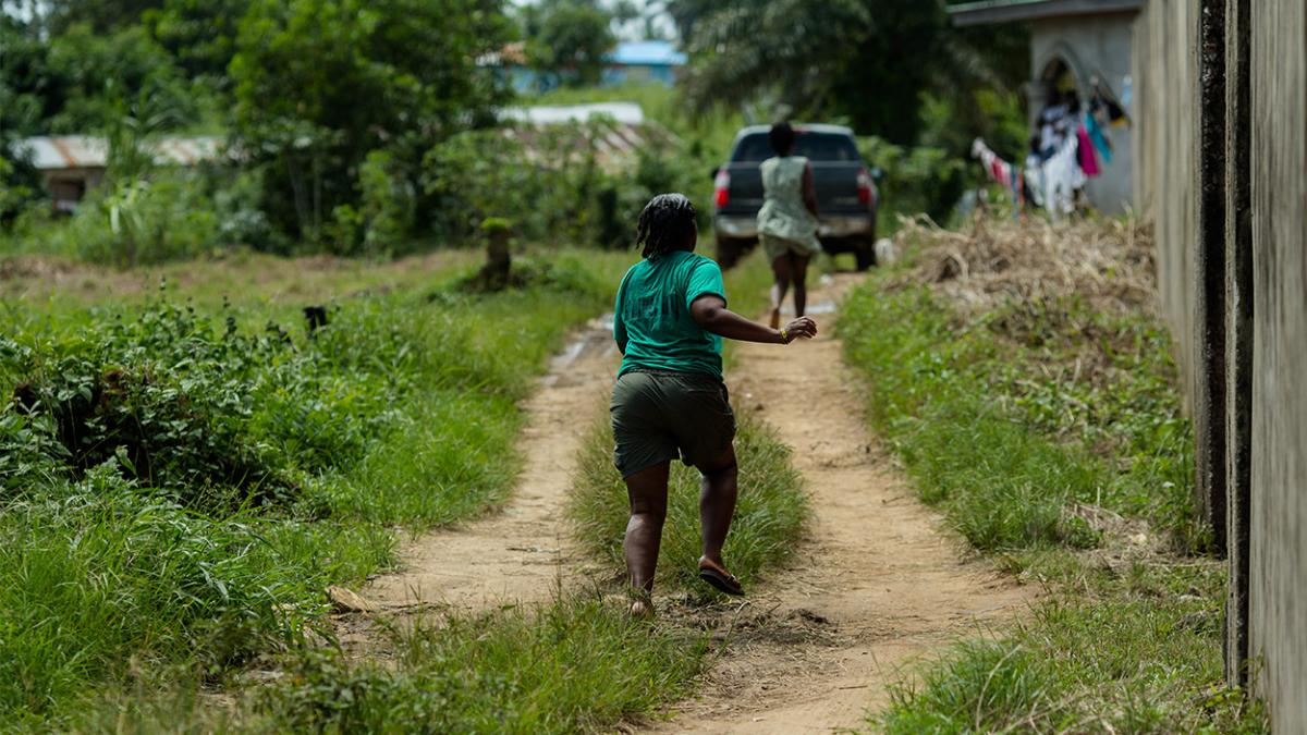 A girl running on a dirt road