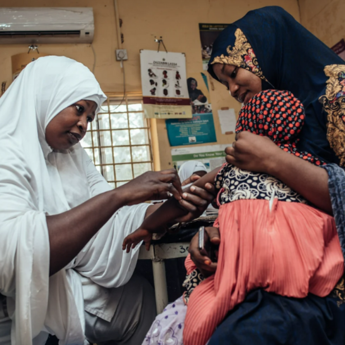 A child receives a routine immunization in Nigeria. 