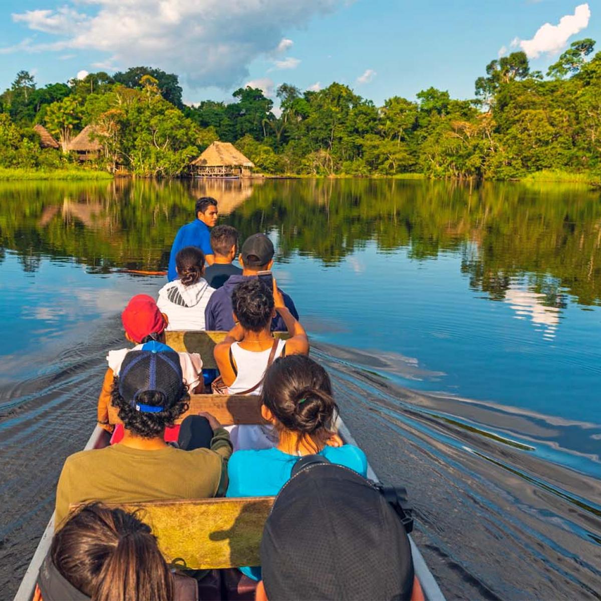 A group of people on a boat on an amazonian river