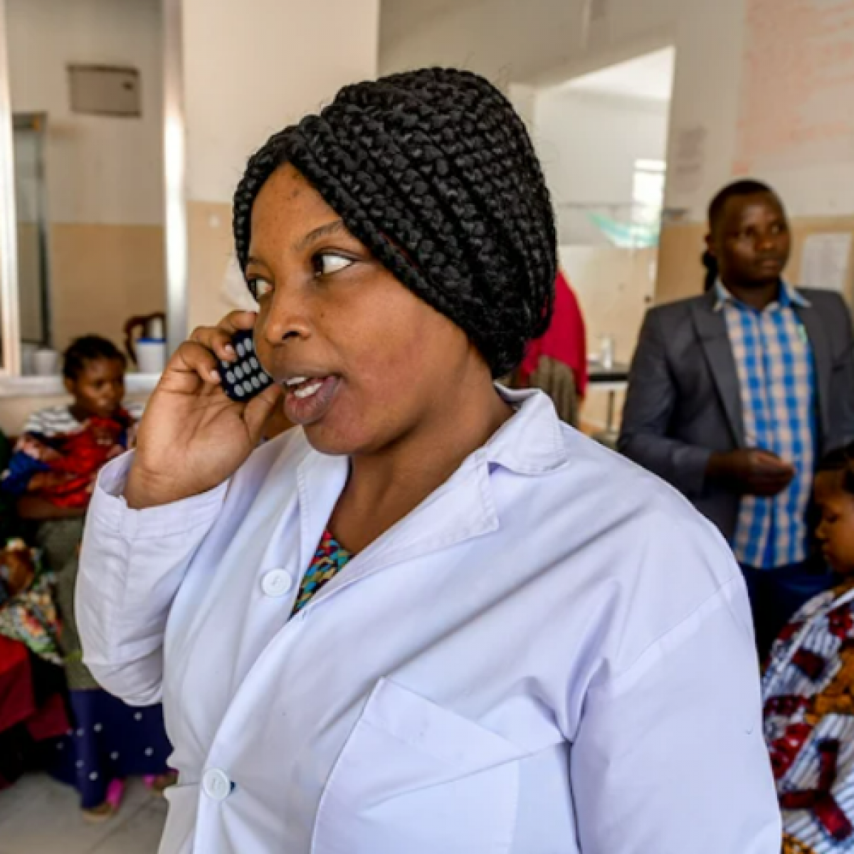 Health workers in northern Tanzania using a new phone call referral system, developed by USAID in partnership with the Government of Tanzania, to fast-track decision-making and prevent needless deaths of mothers and newborns during childbirth. 