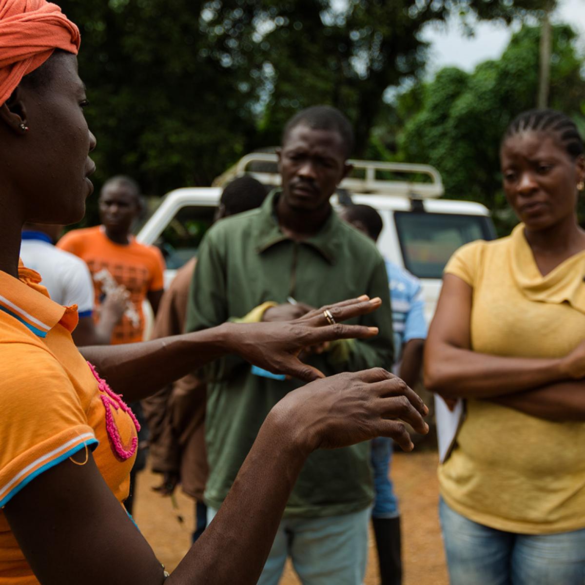 A woman talks to a group of people