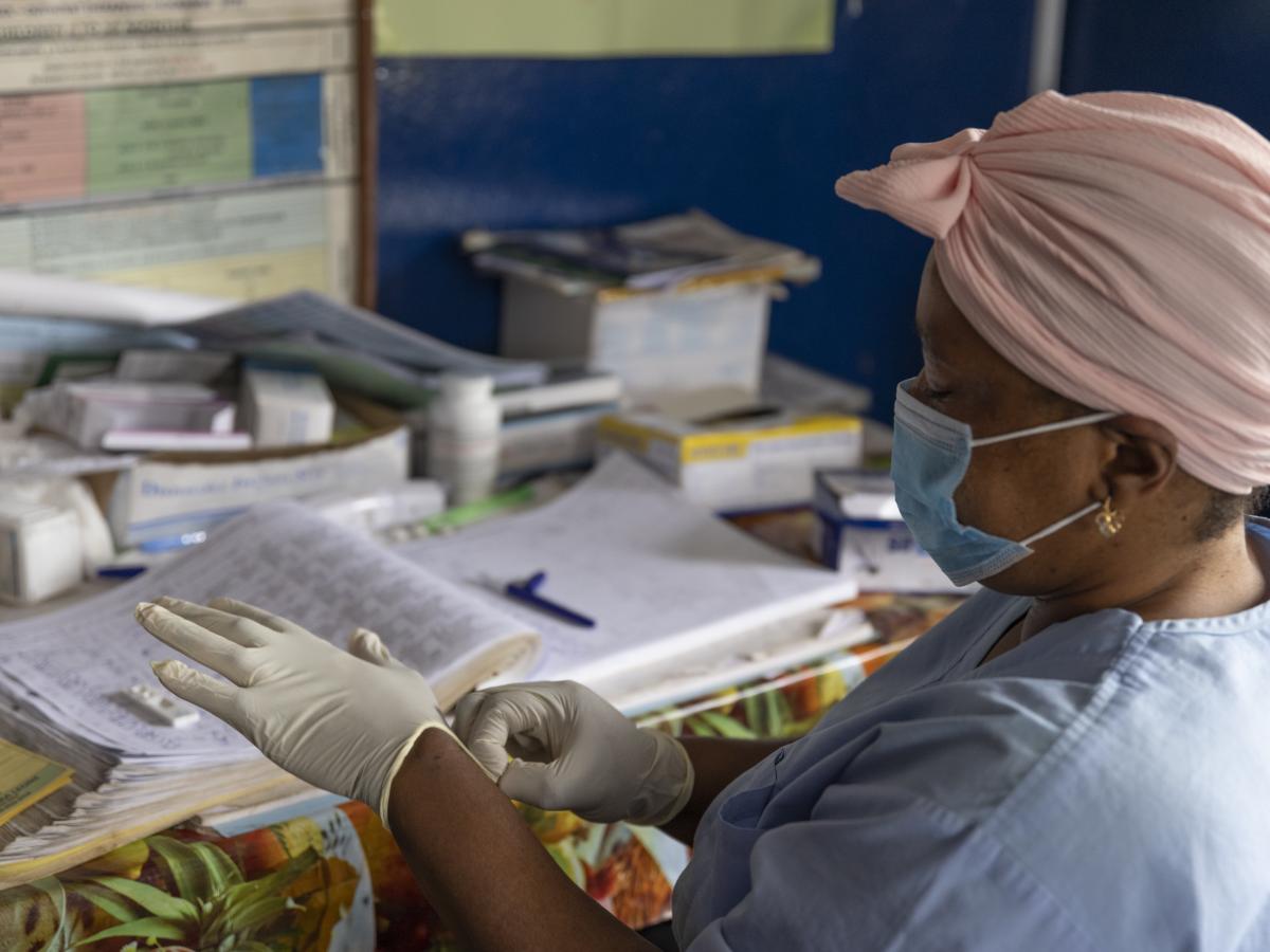 A nurse prepares to perform a malaria test