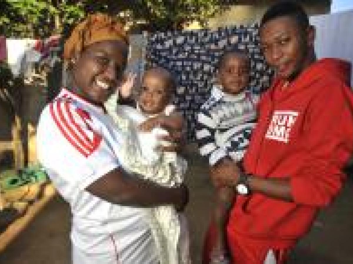 Angelina January, 25, with her husband Hasnol Hemedi, 28, and their 2 children Lenon, 3, outside in their house in Mtwara, Tanzania.