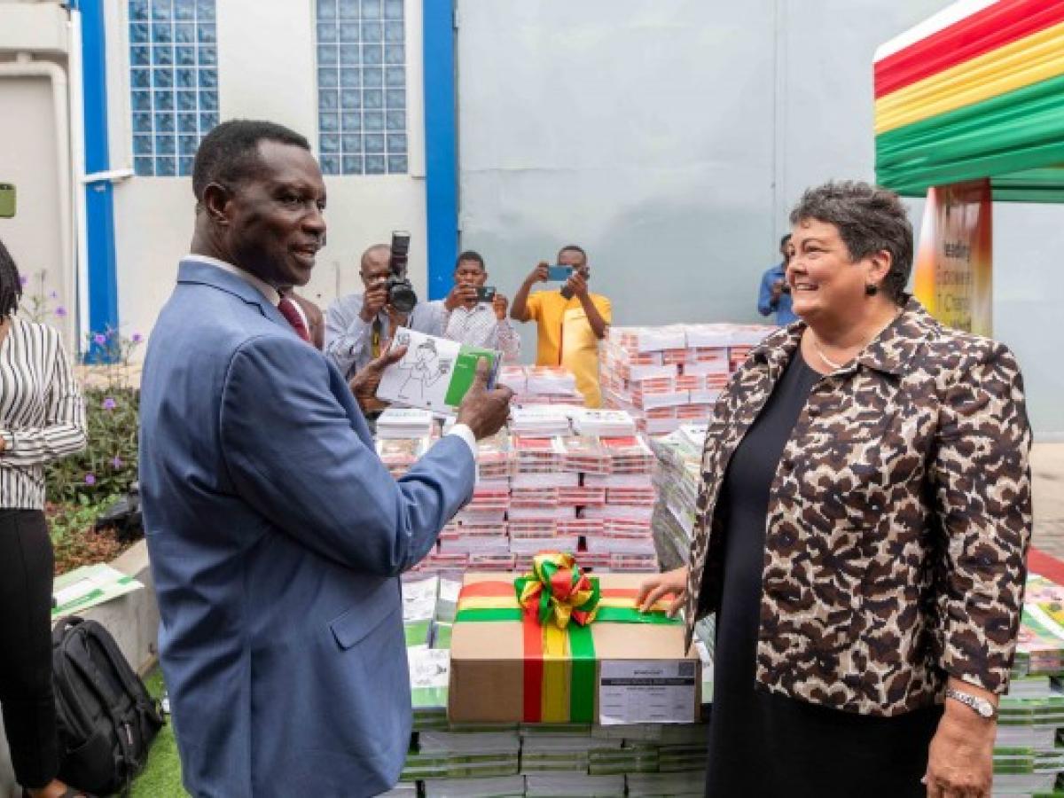 Ambassador Palmer handing over the books to Ghana's Minister of Education