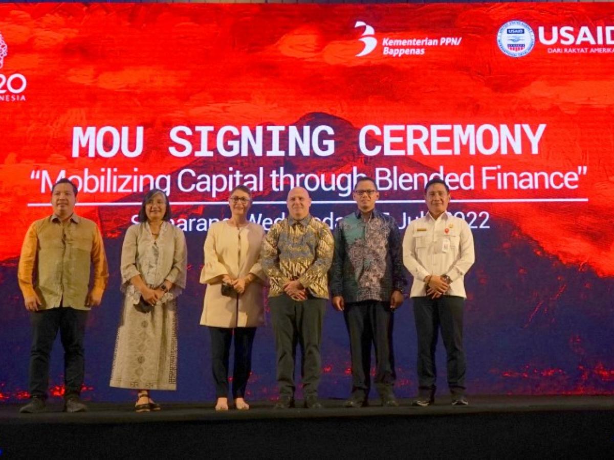 Group of people standing on stage at the July 2022 MOU Signing Ceremony in Indonesia