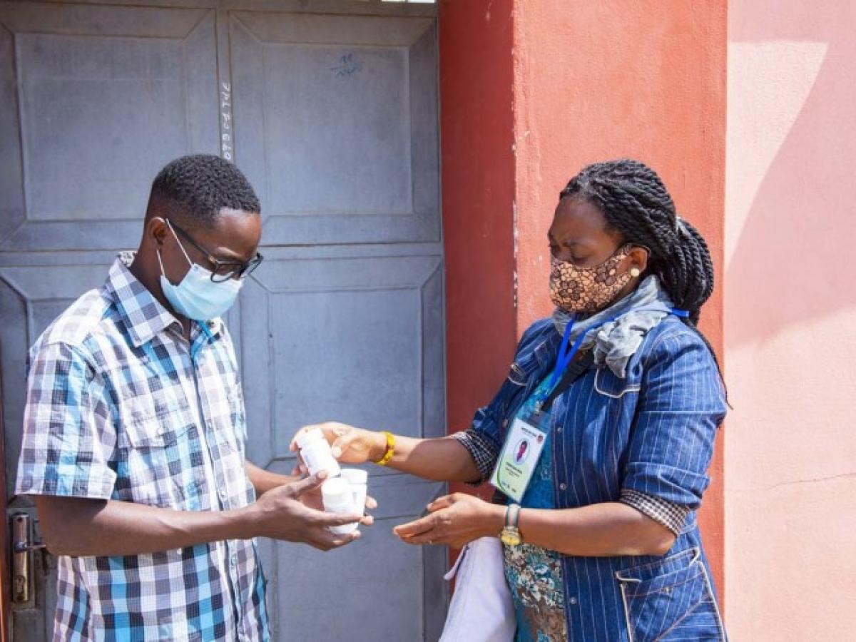 A client receives their antiretroviral treatment (ART) through home delivery in Togo.