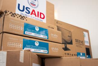 USAID-branded computer boxes in a storage room