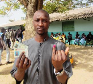 Senegalese holding his ID and voter's card after casting his vote in the 2012 presidential elections
