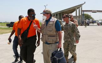 On August 21, DART Leader Tim Callaghan and Government of Haiti Directorate for Civil Protection Director Dr. Jerry Chandler prepare to board a JTF-Haiti helicopter to visit hard-hit areas. 