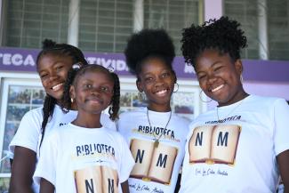 Group of young ladies from a Garifuna community in La Ceiba, Honduras pose for a group photo.
