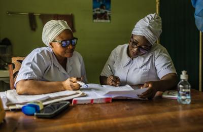 Adama Musah is the midwife at Tamale Reproductive and Child Health Center in northern Ghana confers with a colleague. 