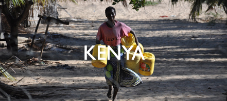 A man carries water jugs in Kenya
