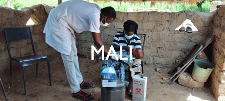 A health care worker advises a mother in Mali