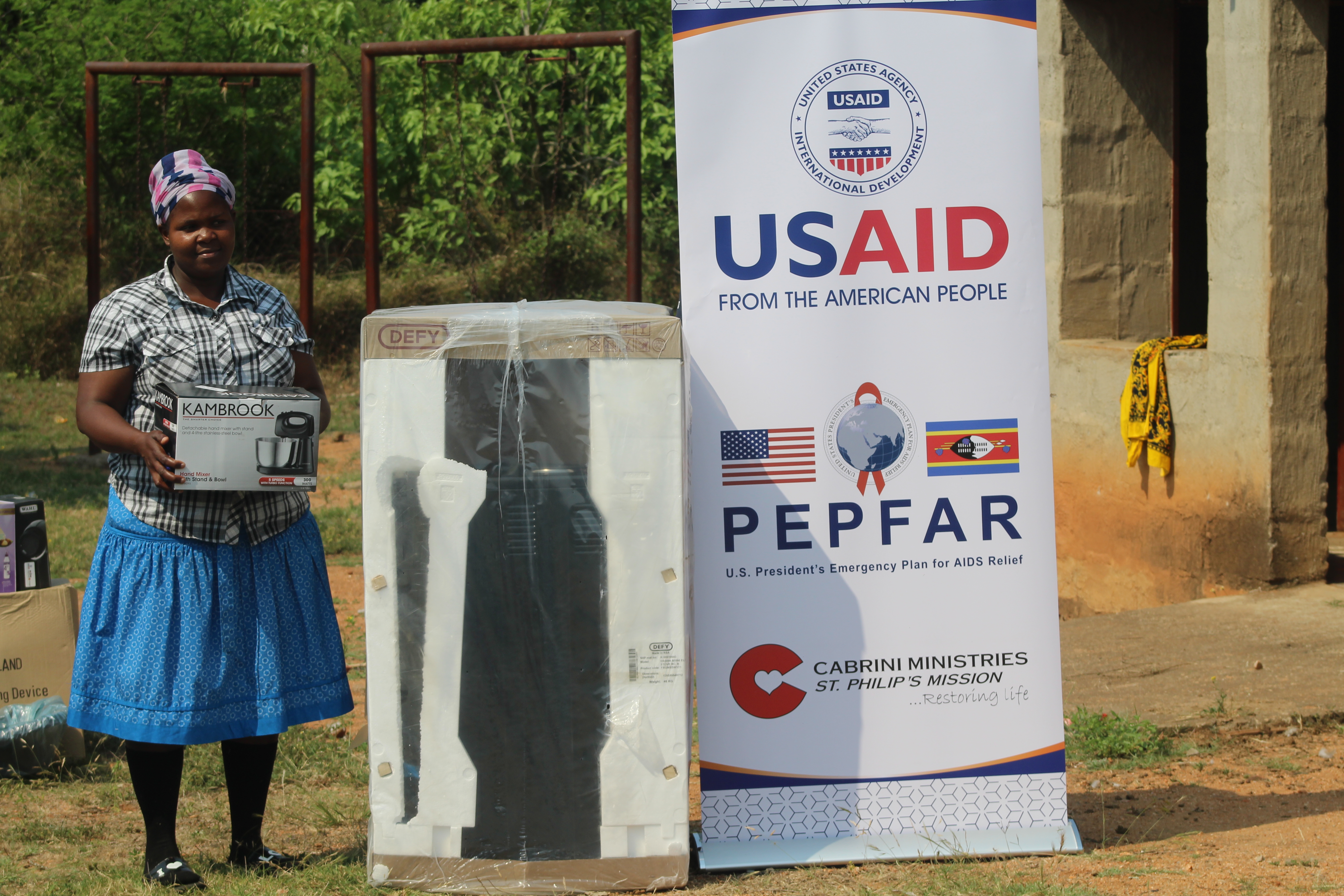 Ncobile receives the equipment needed to start her own small businesses through USAID support.