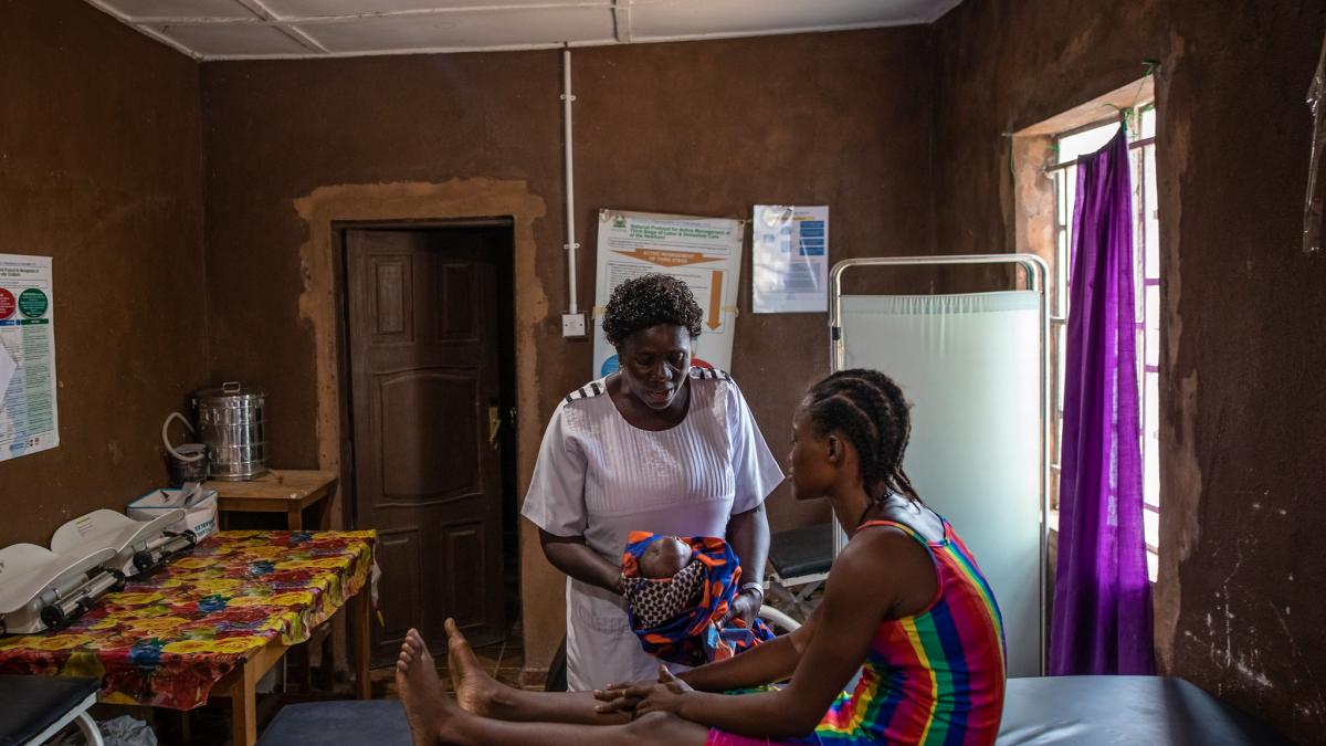 Nurse attends to patient at the Rogbere Community Health Center which was recently electrified.