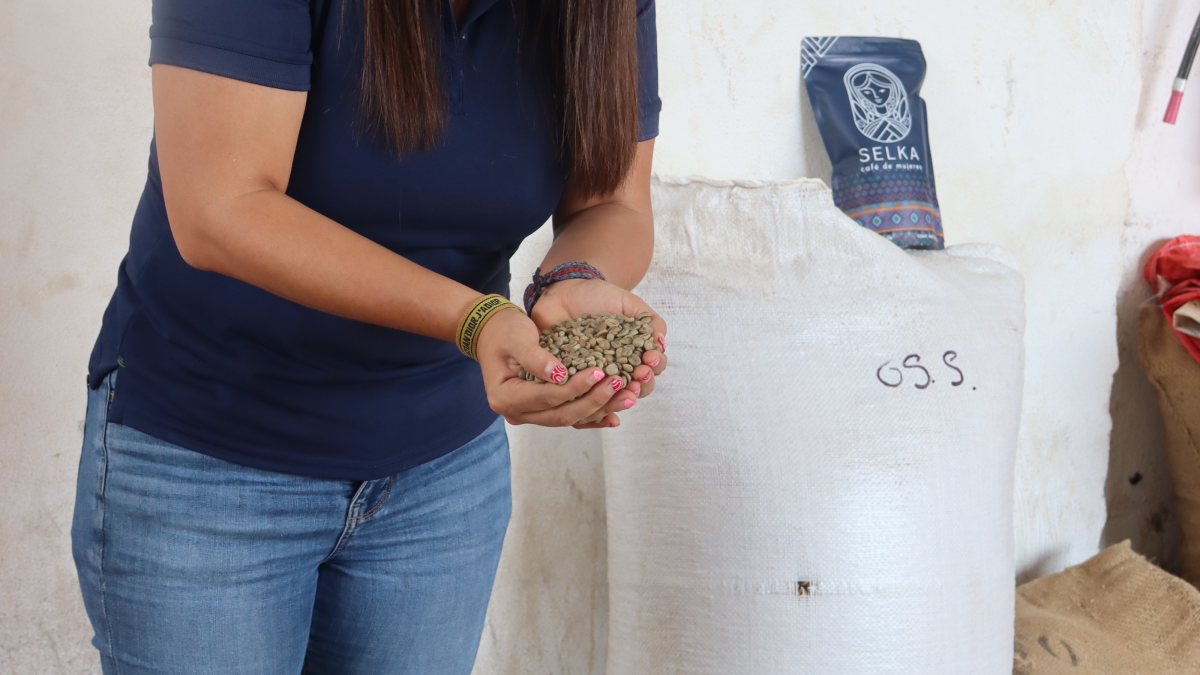 Isabel Camacho is a smallholder coffee producer from Chiapas. Here she holds coffee beans from the cooeprative she leads.
