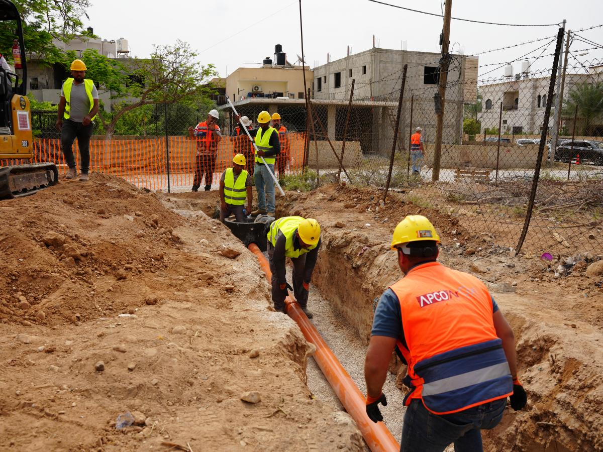 Construction workers install sewer lines through the USAID-supported Jericho Wastewater project