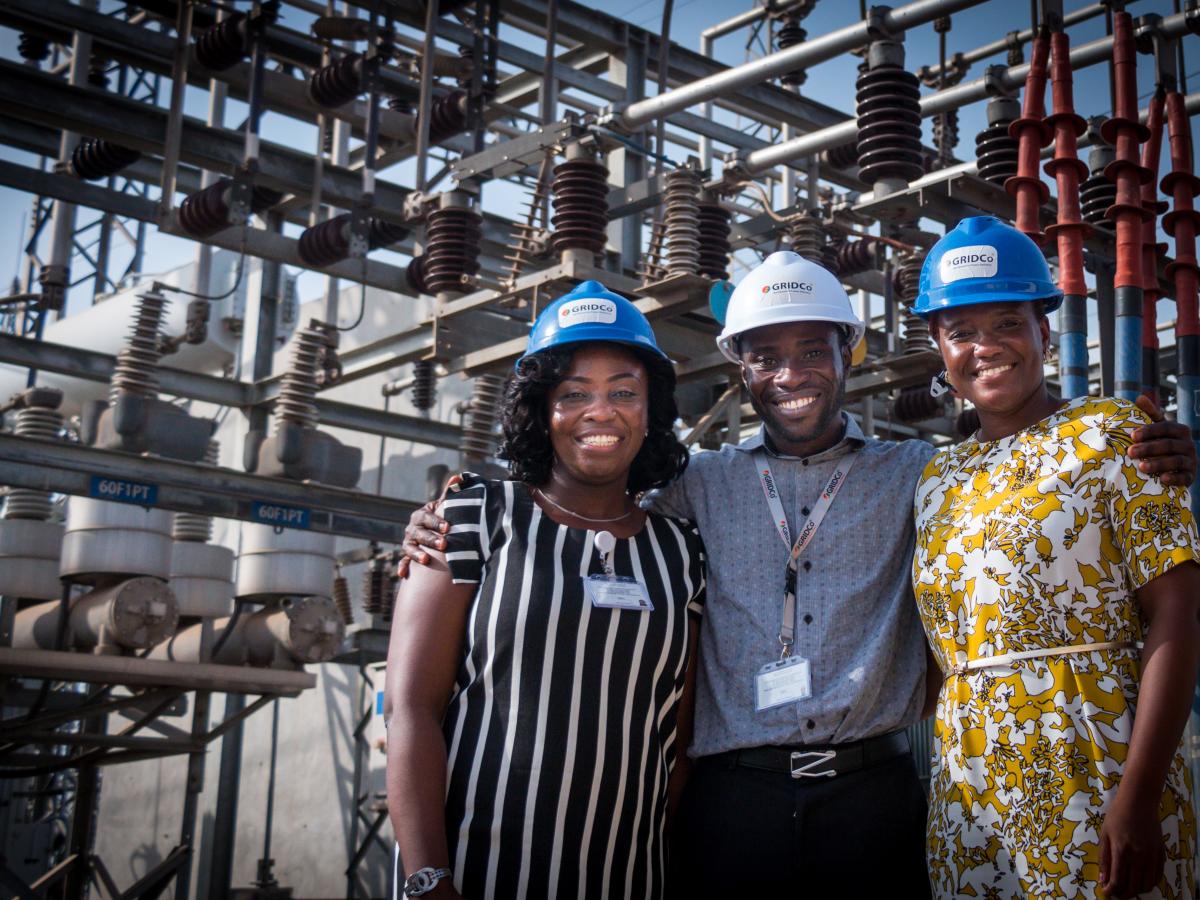 Three people visiting Ghana's GRIDCo substation in Tema