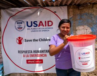 A woman holding an emergency kit in Peru