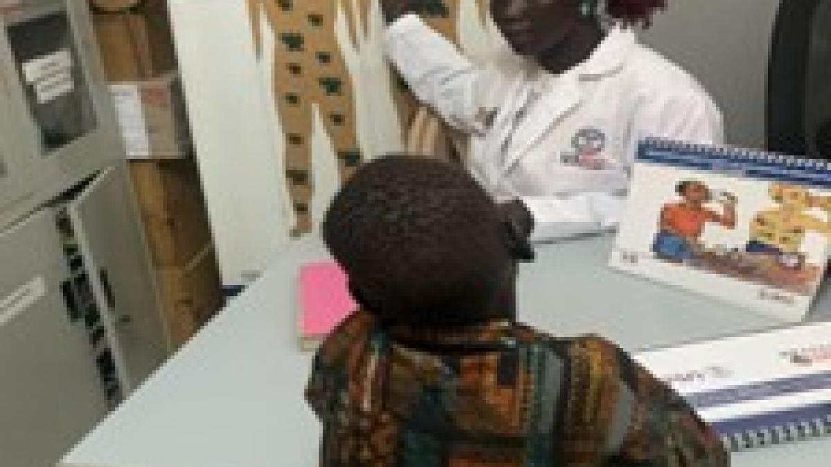 John meets with a health care provider at a USAID-supported health facility. 