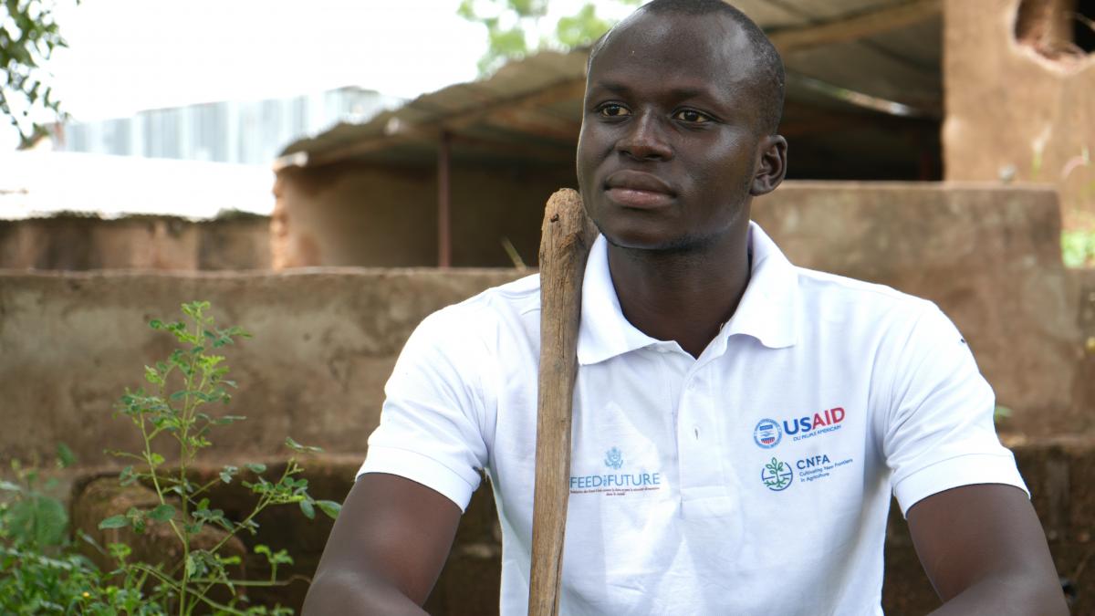 Mamadou Ballo seated in front of the fish pond he used as a composting pit.