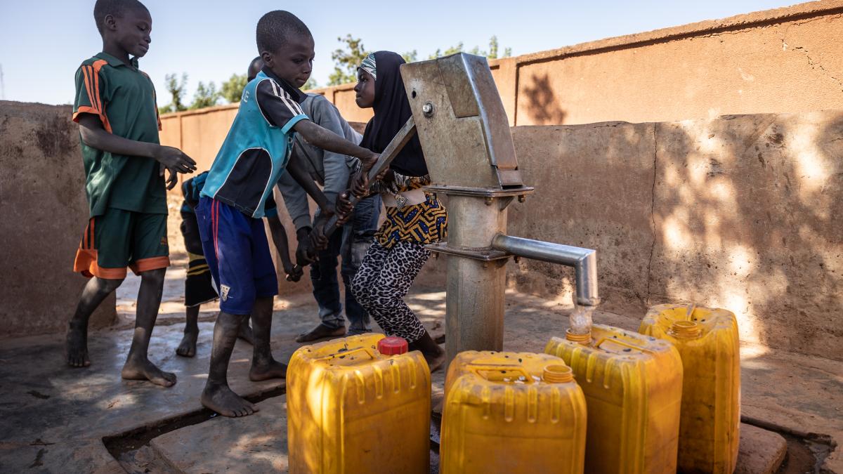 Children at a water pump in Burkina Faso
