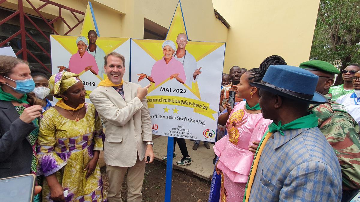 Ambassador Fitrell poses in front of the Gold Star at the Kindia National Midwifery School.