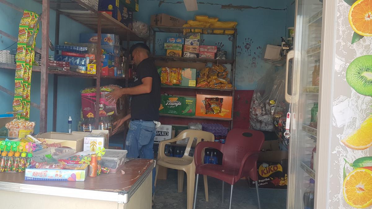 Marwan organizes his convenience store in Sinjar.