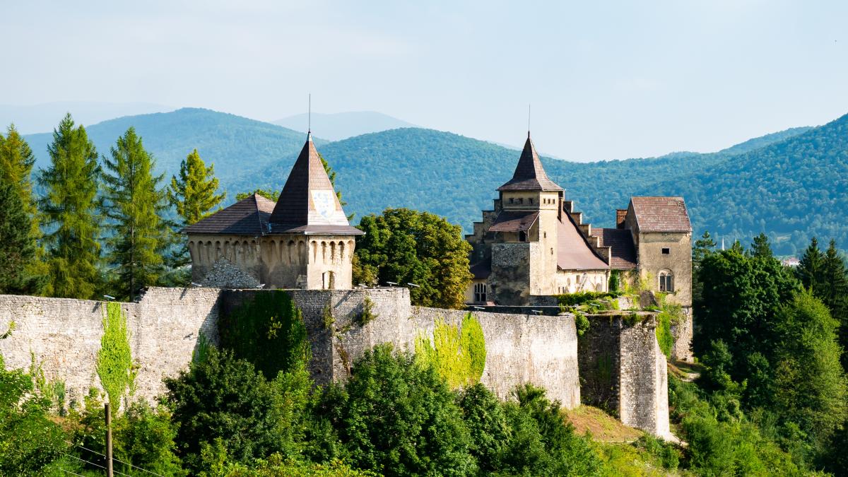 Scenic images of Ostrozac, a historical medieval fortress and castle, perched on a hill overlooking the Una river.
