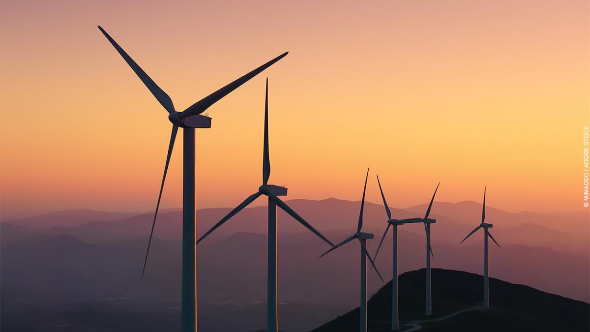 Wind turbines in front of a sunset