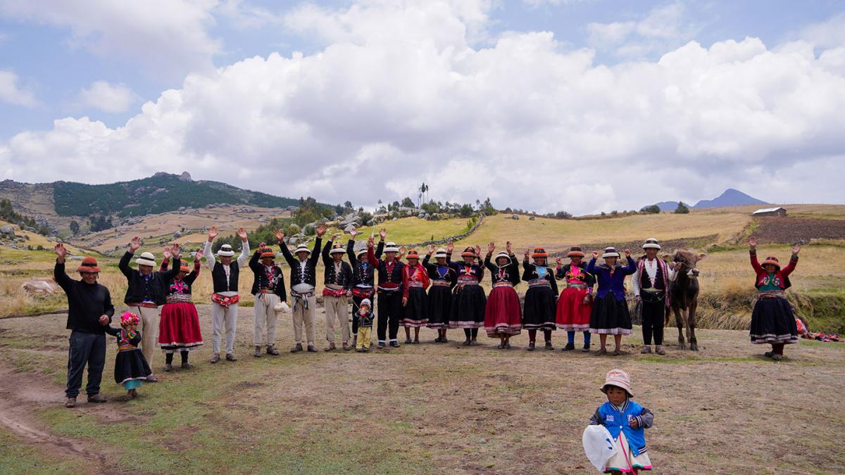 Men and women from the Chillan Kayshun association greeting and raising their hands