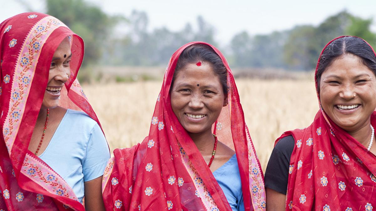 Close up of three women smiling in a field