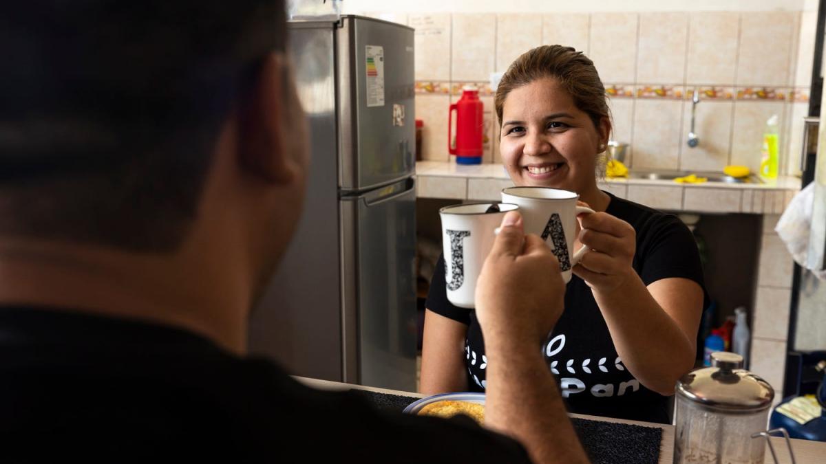 Adriana and Jose drinking coffee during a moment of rest in their kitchen.
