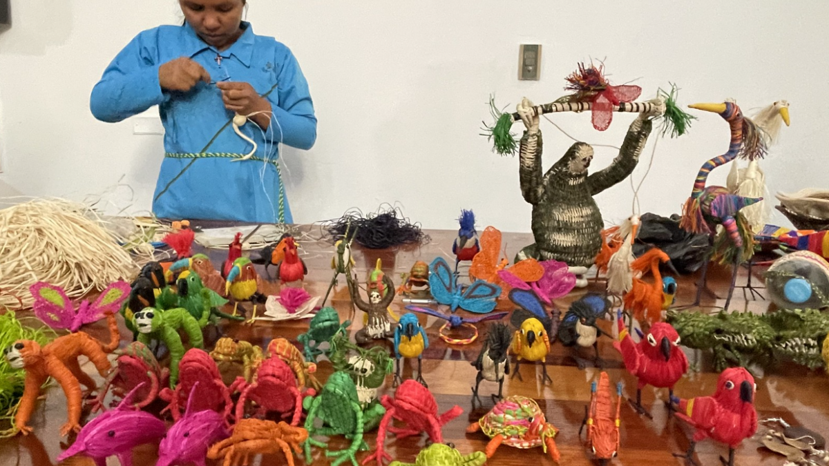 Artisan woman works with chambira fiber producing handmade products 