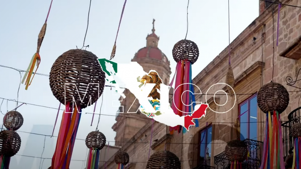 Screenshot showing decorations hanging on a street in Mexico with a map of Mexico overlaid