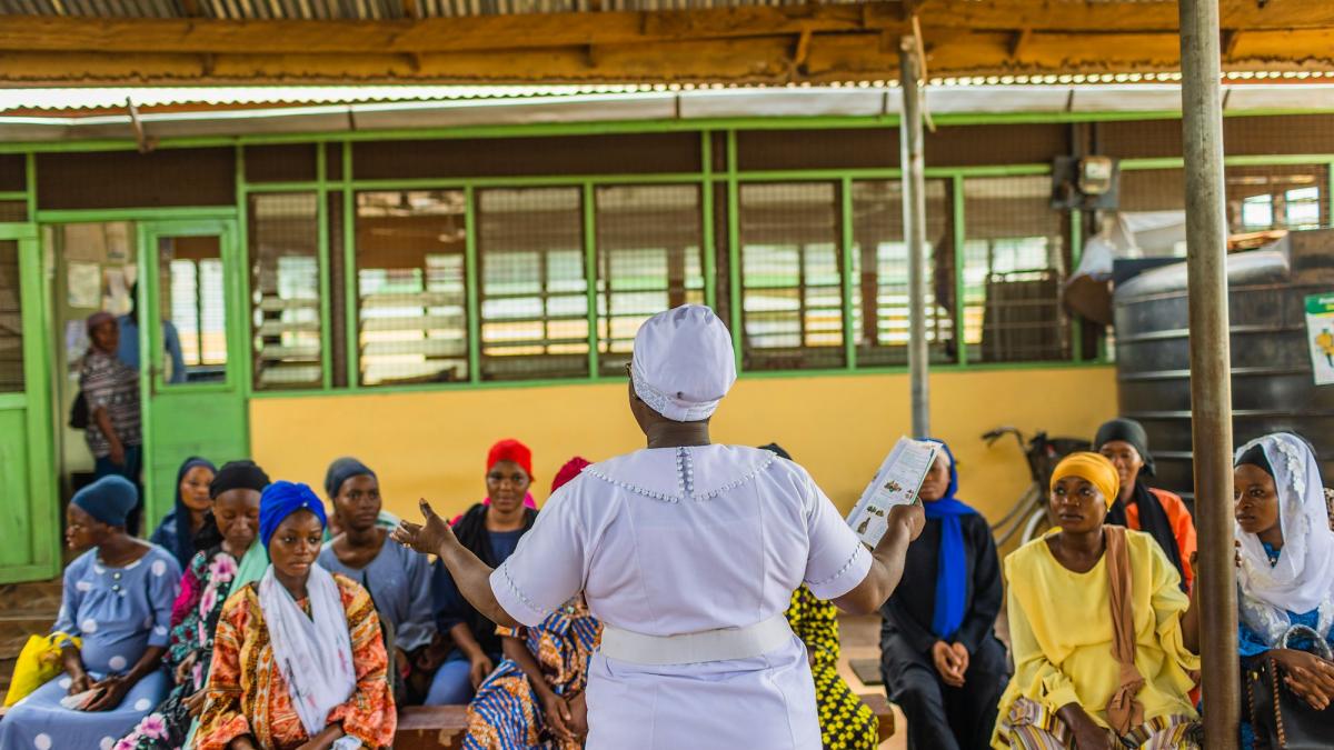 Adama Musah stands in front of a group of women teaching as the lead midwife at Tamale Reproductive and Child Health Center in northern Ghana.