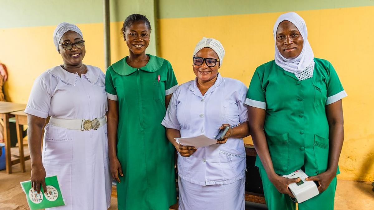 Adama stands with a group of three other healthcare workers at the Tamale Reproductive and Child Health Center in northern Ghana.
