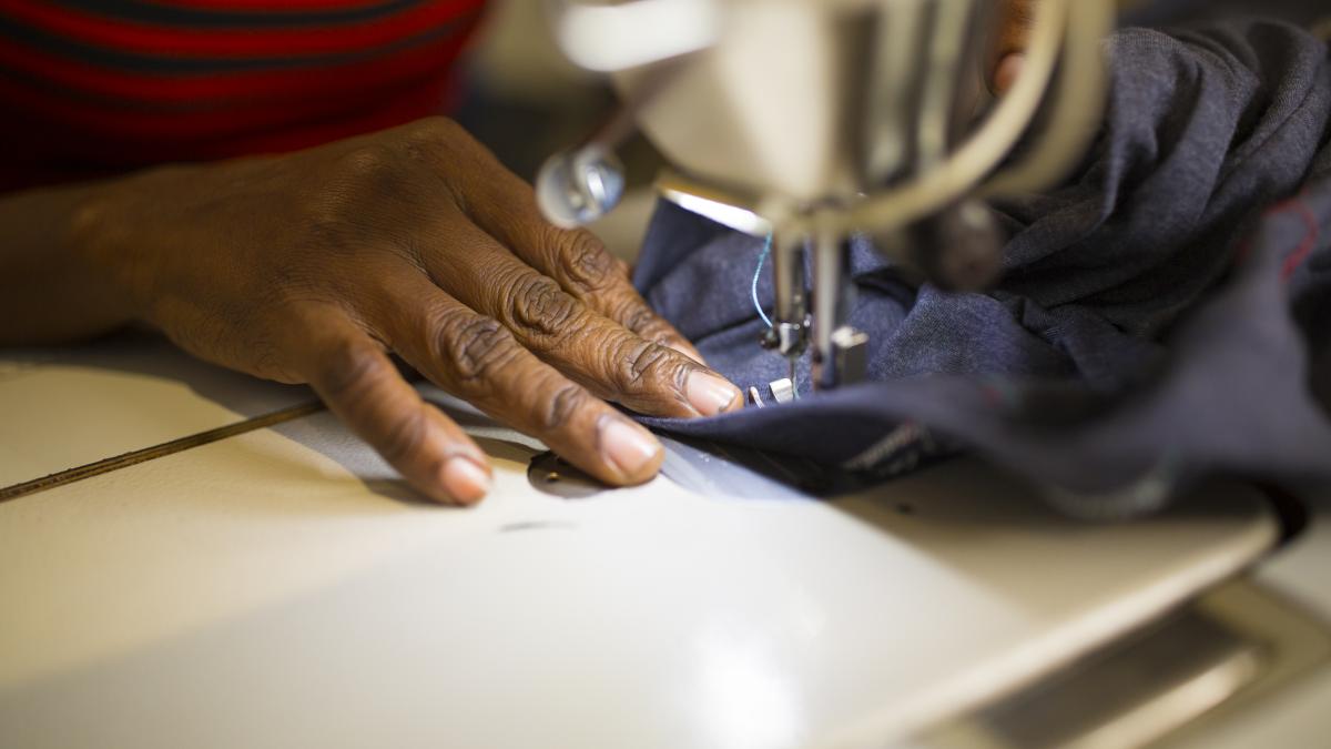A closeup of hands using a sewing machine.