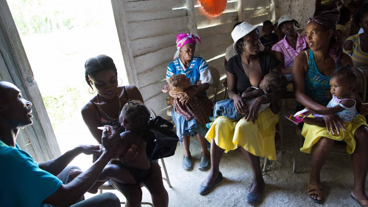 Mothers and their children wait in a clinic